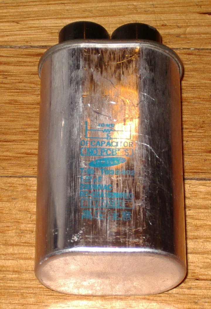 Pre - owned Sharp Microwave High - Voltage Capacitor with 1.07uF and 2200VAC Rating - Part Number RCQZA182WREO